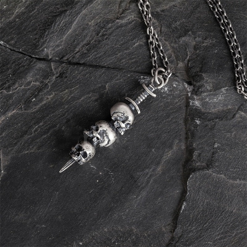Sword through skull pendant