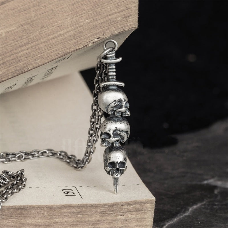 Sword through skull pendant
