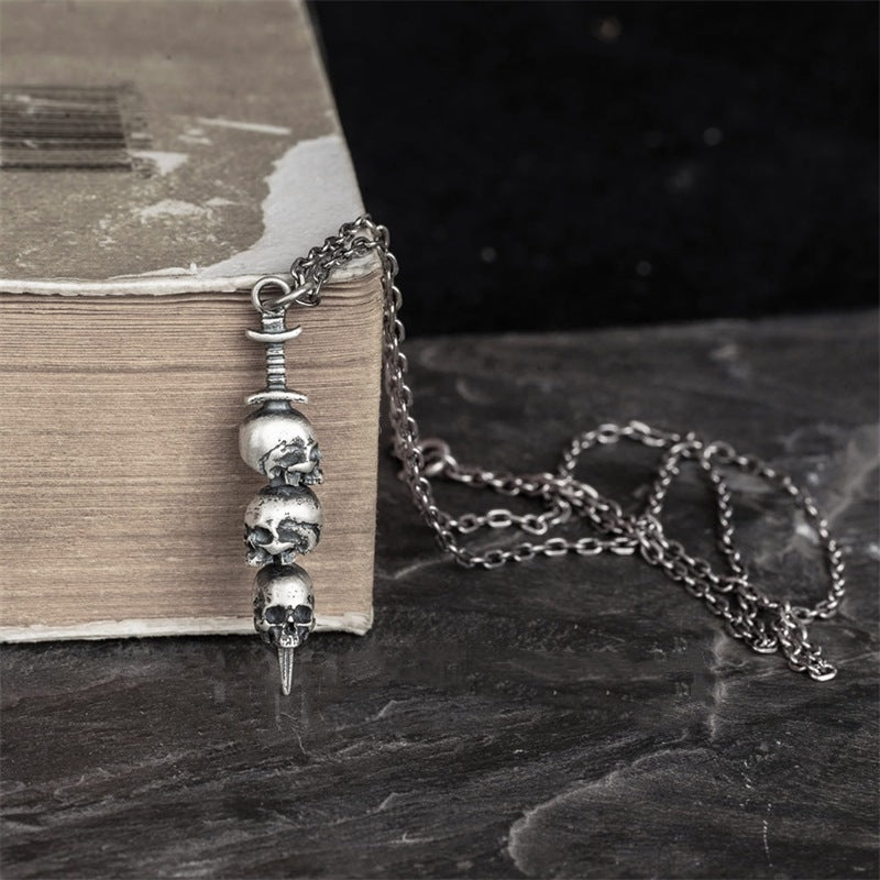 Sword through skull pendant