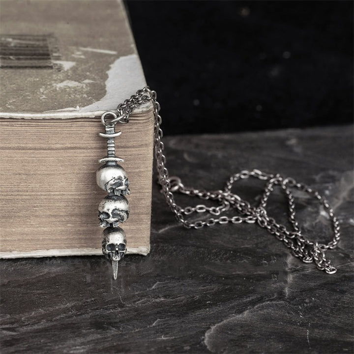 Sword through skull pendant