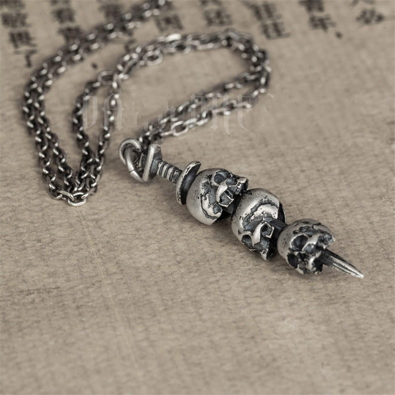 Sword through skull pendant