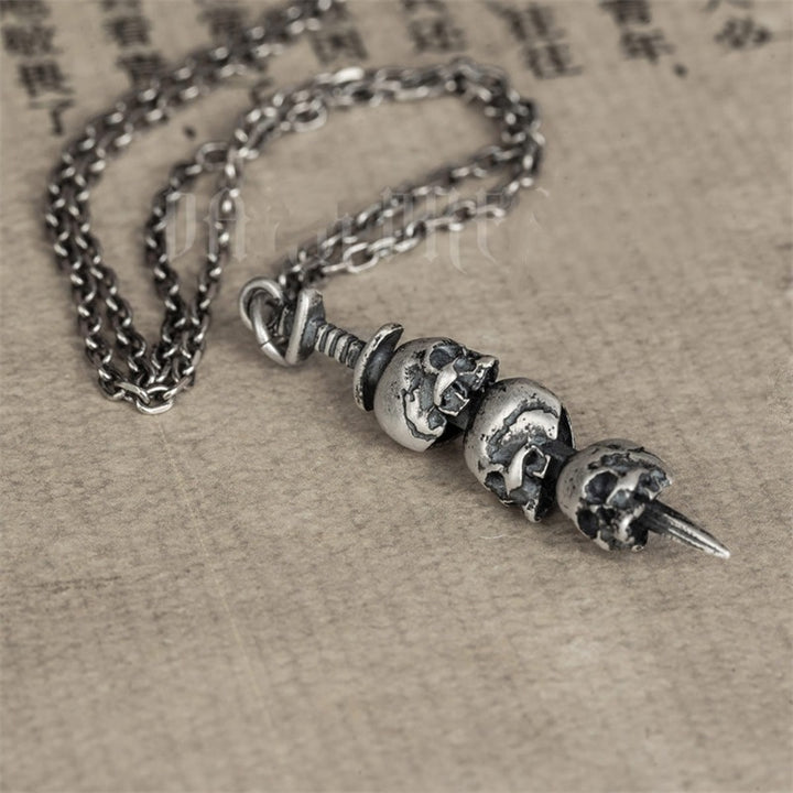 Sword through skull pendant
