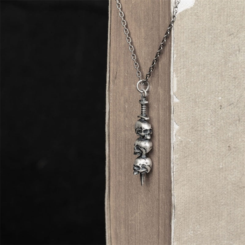Sword through skull pendant